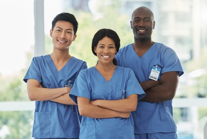 Portrait of a group of medical practitioners standing together with their arms crossed in a hospital assisted living tucson